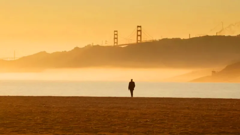 Una figura solitaria contempla el puente dorado